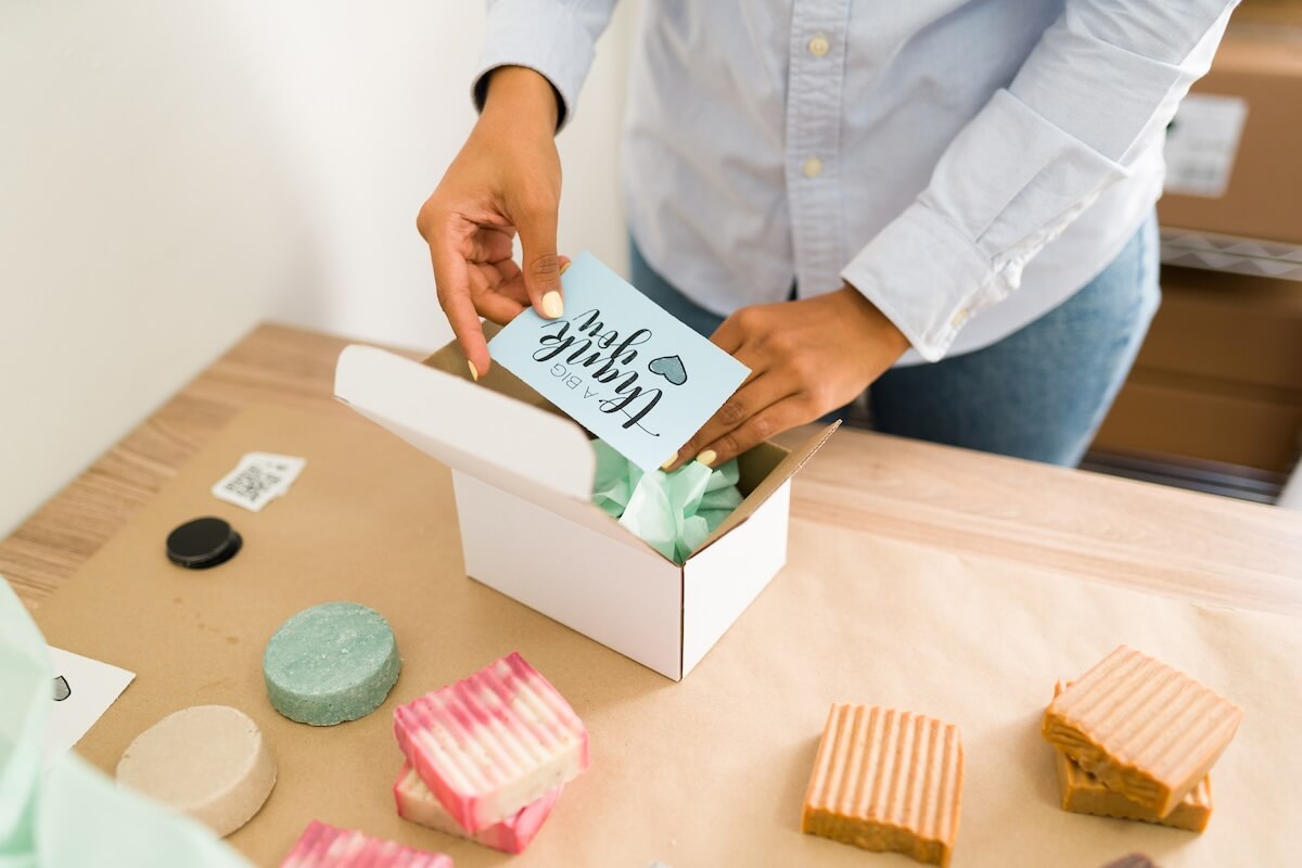 Customer unboxing a package with a personalized thank you note